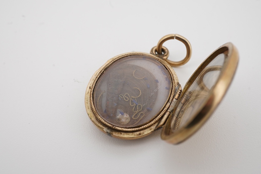 A Victorian gold plated and black enamel set oval mourning locket, 26mm. Condition - poor to fair